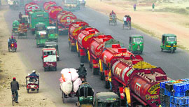 The police escort oil tankers during a strike called by the opposition, in Dhaka on Monday.