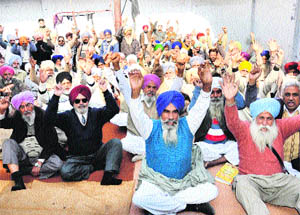 Members of the PRTC Pensioners Association stage a protest against the managing director of the PRTC, near the bus stand in Bathinda, on Tuesday. 