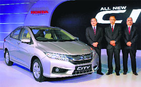 Hironori Kanayama (C), president and CEO of Honda Cars India Ltd, Yoshiyuki Matsumoto (L), managing officer of Honda Motor Company and HSCI senior vice-president and director Raman Kumar Sharma (R) at the launch of the "New 4th Generation Honda City" in New Delhi on Tuesday.