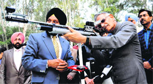 UT Administrator Shivraj V Patil tries his hand at shooting during the opening ceremony of the 10-meter Air Gun Shooting Range at Lake Sports Complex in Chandigarh on Tuesday. 