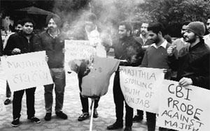 NSUI activists protest against Bikramjit Singh Majithia at Panjab University in Chandigarh on Tuesday.