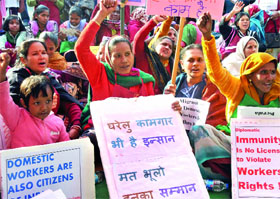 Migrants and domestic workers raise slogans during a demonstration for their rights at Jantar Mantar in New Delhi on Tuesday.