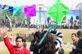 People enjoy kite flying during the International Kite Festival-2014 at Central Park, Connaught Place, in New Delhi on Tuesday.