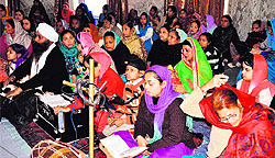 Devotees recite hymns during the birth anniversary celebrations of Guru Gobind Singh at Gol Gurdwara in Haridwar on Tuesday