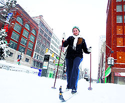 A woman skies to work through thick snow along Woodward Avenue in Detroit, Michigan, on Tuesday