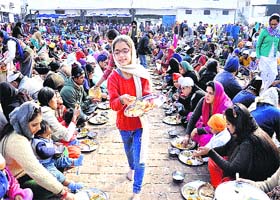 Good spirit: A girl serves langar at a gurdwara on Gurpurb in Jalandhar on Tuesday