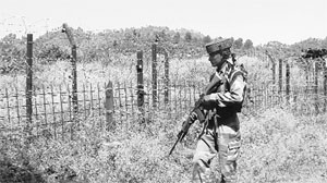 A soldier patrols a forward area in Poonch district.