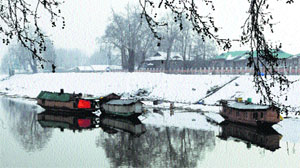 Snow accumulates on the banks of the Jhelum river in Srinagar on Tuesday.