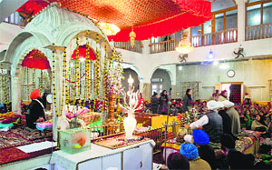 Devotees pay obeisance at a gurdwara on the birth anniversary of Guru Gobind Singh in Srinagar on Tuesday.