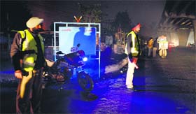 Policemen check vehicles at a naka near Chand Cinema in Ludhiana