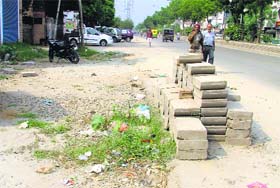 Work on fixing interlocking tiles on Gill Road at Ludhiana is yet to be completed