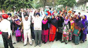 Verka Milk Plant employees hold a protest outside the milk plant in Bathinda on Wednesday.