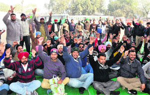 Members of the Contract PRTC Workers Union (Azad) raise slogans during a strike in Bathinda on Wednesday. 