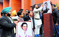 Youth Congress workers paste posters of Congress president Sonia Gandhi and general secretary Rahul Gandhi on a wall of the community centre in Sector 20, Chandigarh