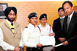 Constables Sonia Dhankar and Poonam being rewarded by UT IGP RP Upadhyaya for their act of bravery, in Chandigarh on Wednesday. A student, Gagandeep Singh Dhanoa, was also rewarded for showing bravery in apprehending a snatcher