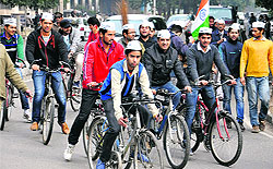 Members of the Aam Aadmi Party hold a cycle rally at Panjab University in Chandigarh on Wednesday