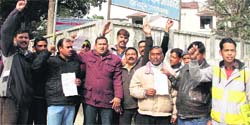 Members of the Tata Magic Owners Welfare Association during a protest at the Regional Transport Office in Dehradun on Wednesday. A Tribune photograph