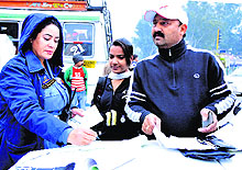 A police official challans a traffic rule violator at Bikram Chowk in Jammu on Wednesday
