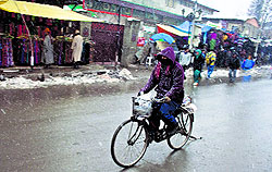 Braving the chill, a hawker goes for his work