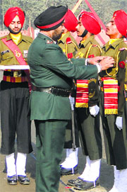 Colonel of the Sikh Regiment, Lt General GS Shergill, awards outstanding recruits at the passing-out parade at the Regimental Centre in Ramgarh