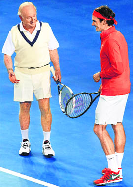 Roger Federer talks with Australian tennis legend Rod Laver during a charity event in Melbourne on Wednesday. 