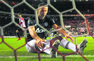 Manchester Uniteds Ryan Giggs reacts after he scored an own goal during their English League Cup semifinal first leg match against Sunderland on Tuesday. 