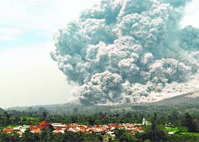Mt Sinabug spews ash and lava in Kiaro, North Sumatra, on Wednesday. More than 20,000 people have been evacuated since the volcano became active on January 4