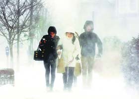 People walk down Elmwood Avenue amid strong Arctic winds in Buffalo, New York, on Tuesday
