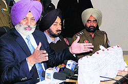 Commissioner of Police Jatinder Aulakh (left) shows the seized heroin during a press conference in Amritsar on Thursday