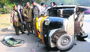 An auto that overturned after being hit by a car at Sector 15, Chandigarh, on Thursday. A person suffered injuries in the accident.