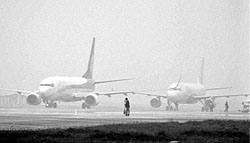 Aircraft seen in dense fog at a runway at Chowdhury Charan Singh Airport in Lucknow on Thursday