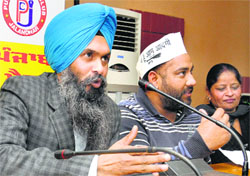 Kamaldeep Singh (left), media adviser to AAP, at a press meet in Jalandhar on Thursday.