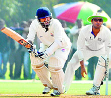 Parvez Rasool plays one to the leg side and scampers for a run as Yuvraj Singh, standing in the slips, looks on