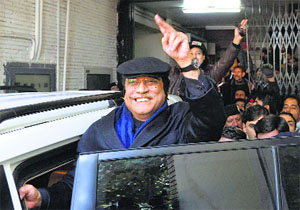 Pakistan's ex-President Asif Ali Zardari, waves as he leaves a court in Islamabad on Thursday.