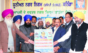 Assistant Municipal Commissioner Kamal Kant Goyal releases the calender of the Dr Bheem Rao Ambedkar Karamchari Union in Bathinda on Friday. 