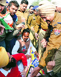 Police officials ask Youth Congress workers to lift the dharna on Ferozepur Road in Ludhiana on Friday