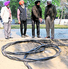 Powercom officials with the wires that were being stolen by the thieves on Friday night in Bathinda on Saturday