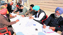 Health Department officials hold a camp at the Mal Godam Road distributing forms to the food business operators for registration in Bathinda on Saturday