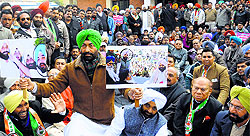 PPCC spokesman Sukhpal Khaira leads a protest against minister Bikram Majithia in Jalandhar on Saturday. Protesters were not allowed to proceed towards sammelan venue