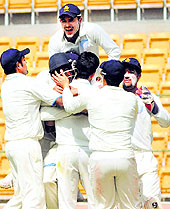 Karnataka celebrate their quarterfinal win over UP in Bangalore; and VRV Singh (right) took his second five-wicket haul of the Ranji season on Saturday