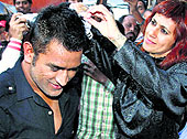 MS Dhoni gets a hair cut during a promotional event in Mumbai