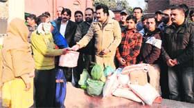 Members of the Akhil Bharatiya Human Rights Welfare Association hand over ration and cash to a couple who were found to be HIV positive