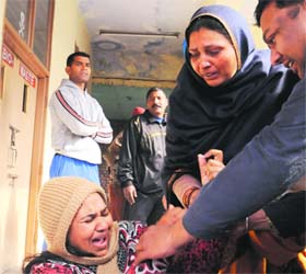 Wailing relatives of Ravinder Singh, who died in a road mishap, at Batala road in Amritsar