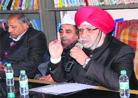 Former Indian Revenue Service official SJS Pall (right) addresses the members of the AAP during a meeting at Ranjit Avenue in Amritsar on Sunday