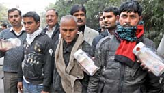 Three members of an international gang arrested in the counterfeit currency case by the Delhi Police Crime Branch in New Delhi on Sunday. Tribune photo: Manas Ranjan Bhui
