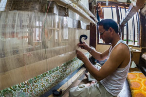 A carpet weaver at work. New machinery and improved, innovative practices are needed for raising productivity otherwise Indian manufacturing would fall behind not only China but also smaller ASEAN countries