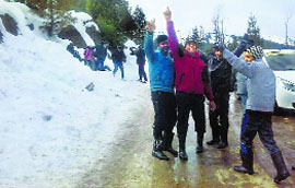 Tourists enjoy amid snow at Patnitop on Sunday.