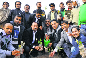 Members of the Jammu Kashmir Nirman Sansthan plant a sapling during the 'Mission Green' at JDA Park in Jammu on Sunday.