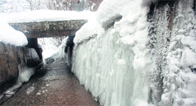 As Srinagar records a minimum of -3 C, icicles hang by a wall
