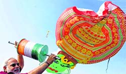 Gujarat CM Narendra Modi flies a kite during the 26th International Kite Festival in Ahmedabad on Sunday. PTI 